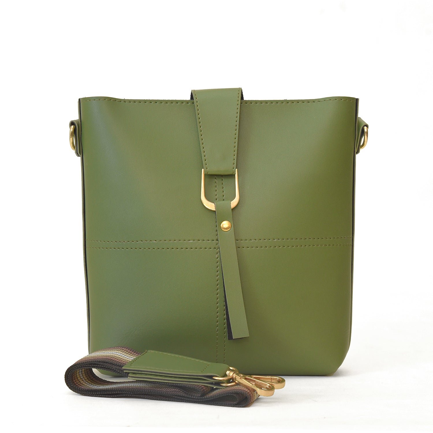 A green leather cross bag with a structured silhouette, gold-tone buckle, and an adjustable strap for versatile wear.