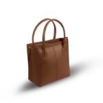 DOVE Shoulder Bag in CHOCO color—premium faux leather handbag with dual handles and an adjustable shoulder strap, available in Pakistan.