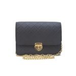 Black NORA cross body bag with golden chain and quilted design.