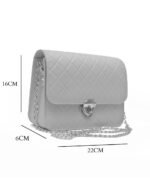 Black NORA cross body bag with golden chain and quilted design.