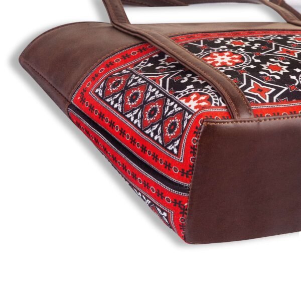 AJRAK ART Shoulder Bag featuring a traditional design and long leather straps, handcrafted in Pakistan.