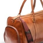 A BERLIN Duffel Bag with a large capacity, premium leather design, sturdy handles, and an adjustable strap for convenient travel in Pakistan.