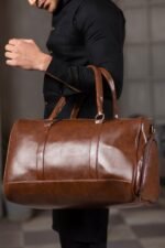 A BERLIN Duffel Bag with a large capacity, premium leather design, sturdy handles, and an adjustable strap for convenient travel in Pakistan.