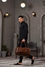 A BERLIN Duffel Bag with a large capacity, premium leather design, sturdy handles, and an adjustable strap for convenient travel in Pakistan.