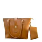 The spacious Caramel Tote Bag, available in a rich brown color, features a secure design with a locking system, a small pouch, and a comfortable leather strap. It offers ample storage space and is available in Pakistan.