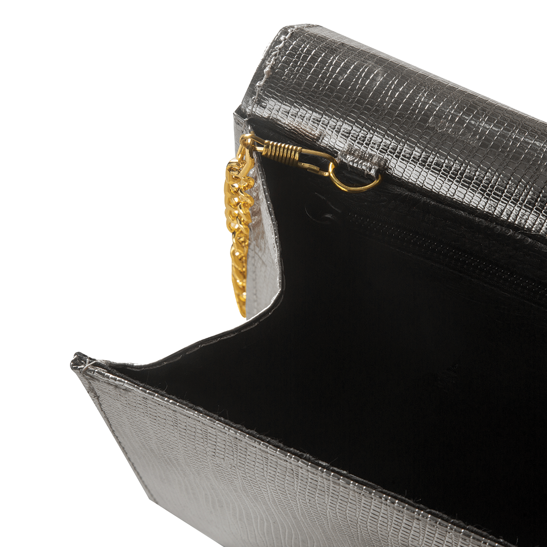 A luxurious hand bag in sleek silver color, with adjustable golden chain, available in Pakistan.