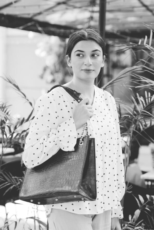 A luxurious tote bag made from crocodile-embossed leather, featuring a spacious interior, In a Black Color with a chain handle strap in pakistan