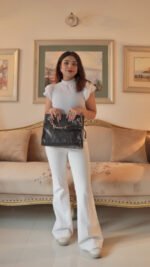 A luxurious tote bag made from crocodile-embossed leather, featuring a spacious interior, In a Black Color with a chain handle strap in pakistan