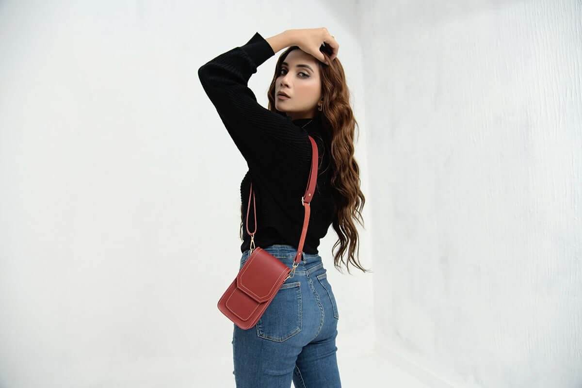 The Mobo Pouch Phone Mini Bag, available in Maroon, features premium leather craftsmanship and comes with a long, adjustable strap. Now available in Pakistan.