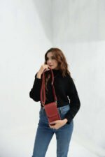 The Mobo Pouch Phone Mini Bag, available in Maroon, features premium leather craftsmanship and comes with a long, adjustable strap. Now available in Pakistan.
