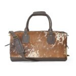 The Moxi Leather Duffel Bag, a handcrafted luxury travel bag with a unique leather design, sturdy handles, and adjustable strap.