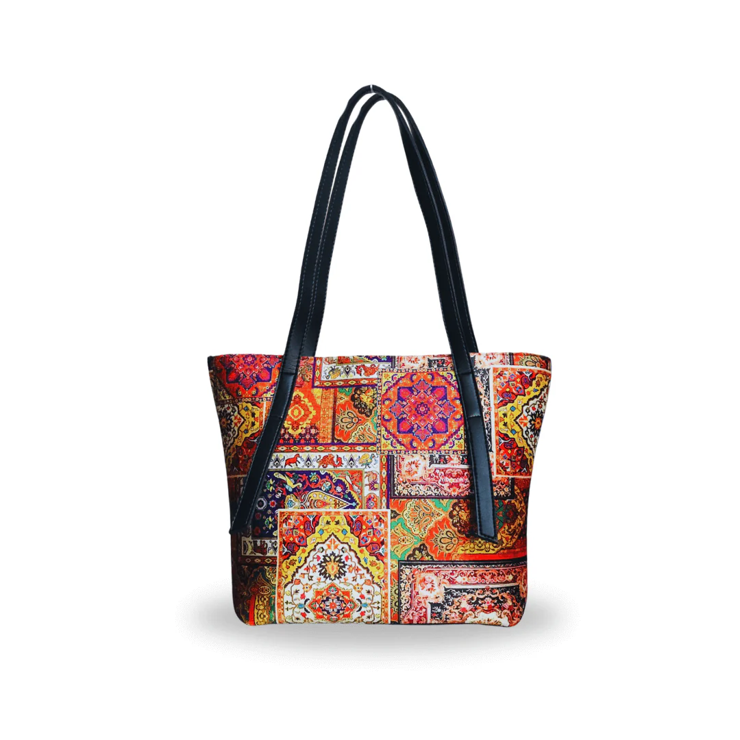 The Rhea Tote Bag, featuring a culturally inspired design on a sleek black base with a durable leather strap, is the perfect accessory for women, whether for special occasions or everyday use.