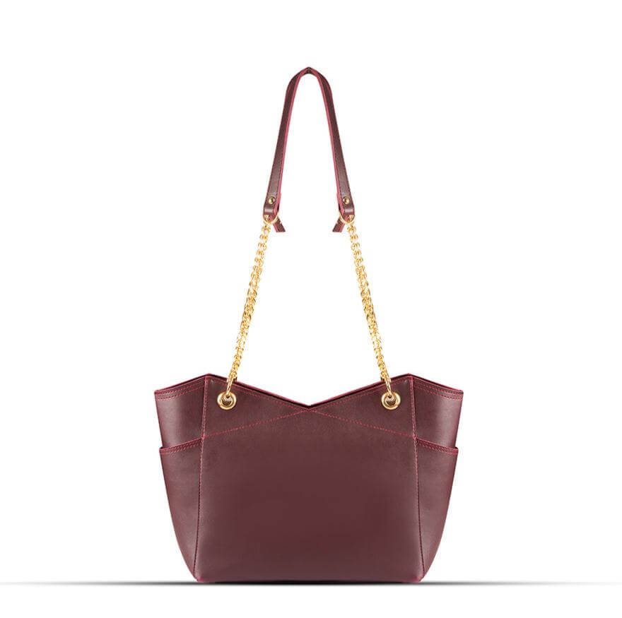 Stylish Tote bag with a gold chain accent and a maroon strap, available in an elegant maroon color. Now available in Pakistan.