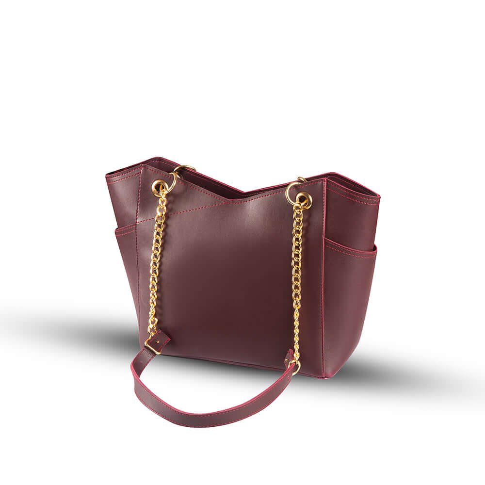 Stylish Tote bag with a gold chain accent and a maroon strap, available in an elegant maroon color. Now available in Pakistan.