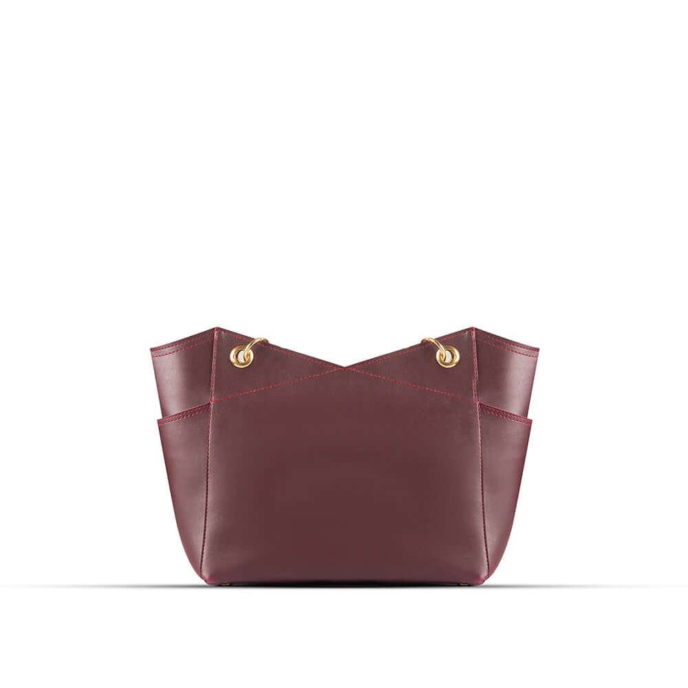 Stylish Tote bag with a gold chain accent and a maroon strap, available in an elegant maroon color. Now available in Pakistan.