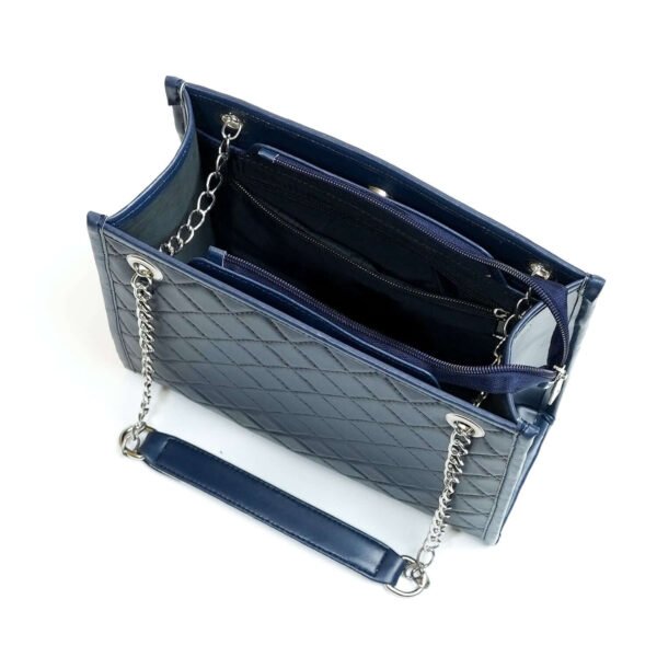 The Sydney Shoulder Bag, designed with premium synthetic leather and a silver-tone metal chain strap, is available in an elegant blue color in Pakistan.