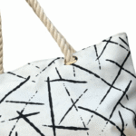The stylish TETRA CANVAS TOTE bag features durable rope handles and a sleek canvas design on a white base. Now available in Pakistan.