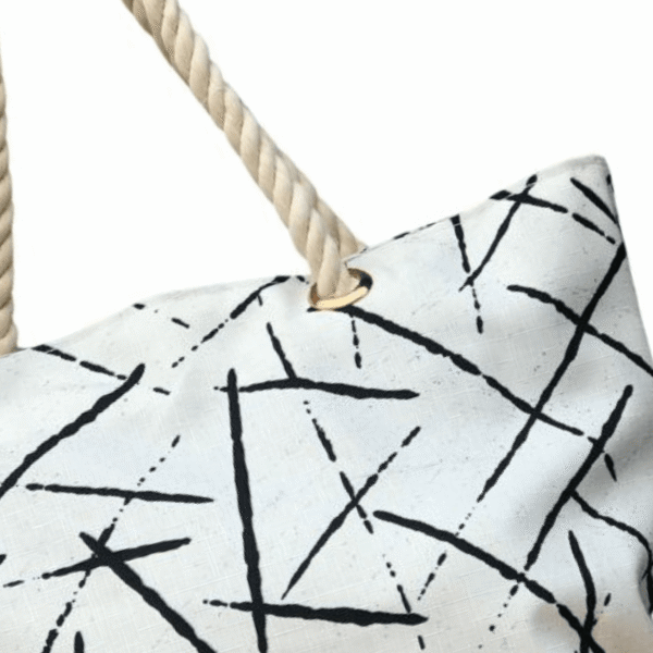 The stylish TETRA CANVAS TOTE bag features durable rope handles and a sleek canvas design on a white base. Now available in Pakistan.