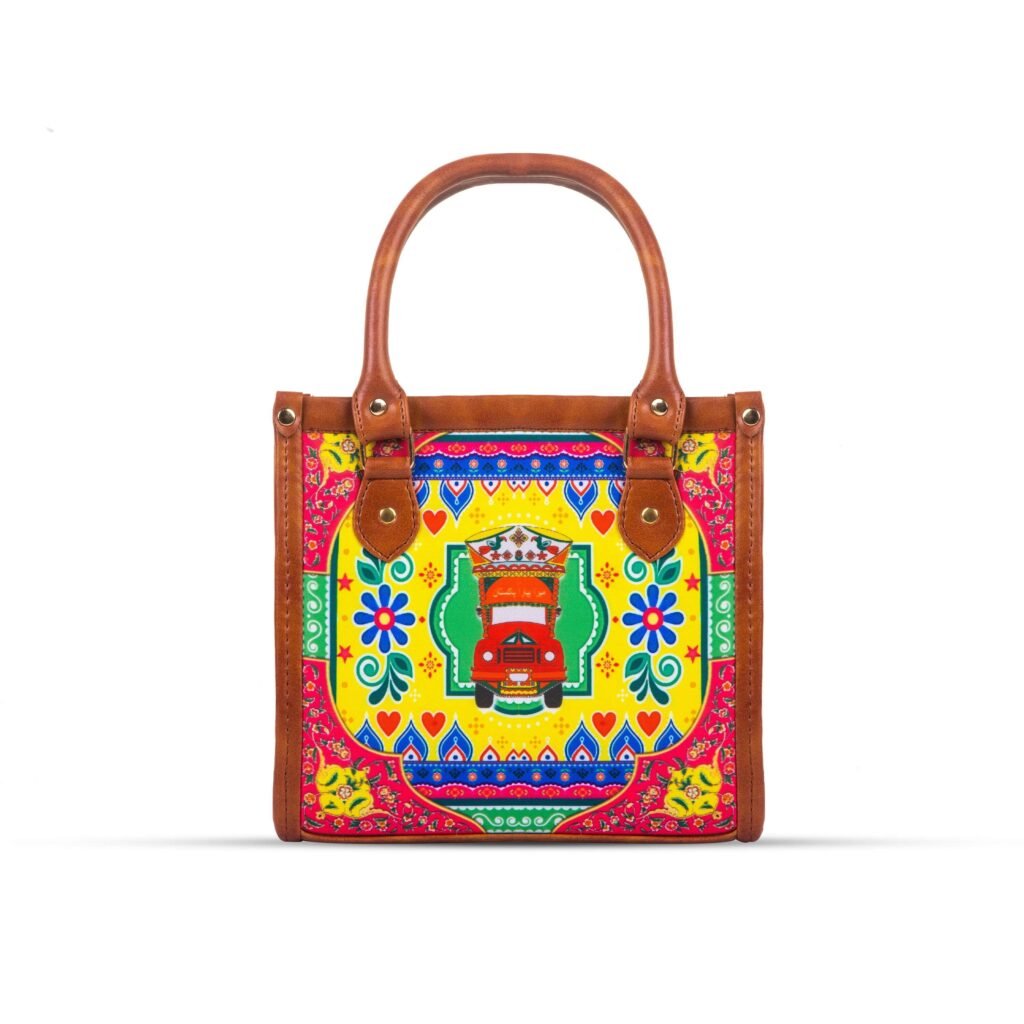 Celebrate Pakistan's vibrant culture with our Truck Art Handbag – a perfect blend of tradition and vibrant colors. Featuring a bold, colorful design paired with a contrasting brown leather handle, it’s a unique accessory that stands out beautifully.