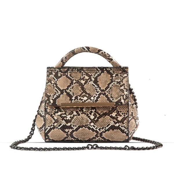 VENOM Shoulder bag premium snake skin material With Charming silver Chain crafted in an elegant brown and beige color combination. Now available in Pakistan.