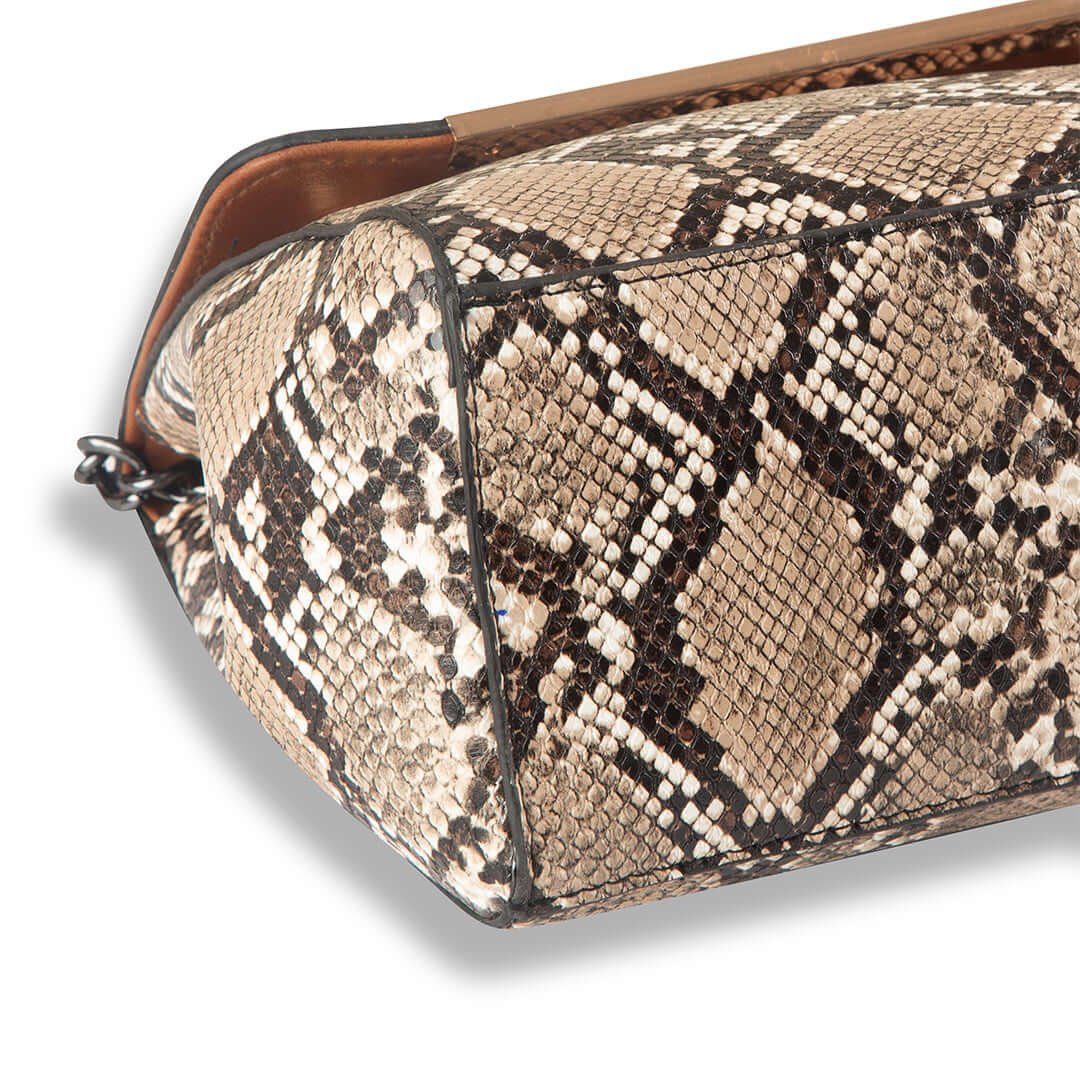 VENOM Shoulder bag premium snake skin material With Charming silver Chain crafted in an elegant brown and beige color combination. Now available in Pakistan.