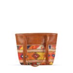 Vivid brown shoulder bag featuring a handcrafted design and a durable leather strap, now available in Pakistan.